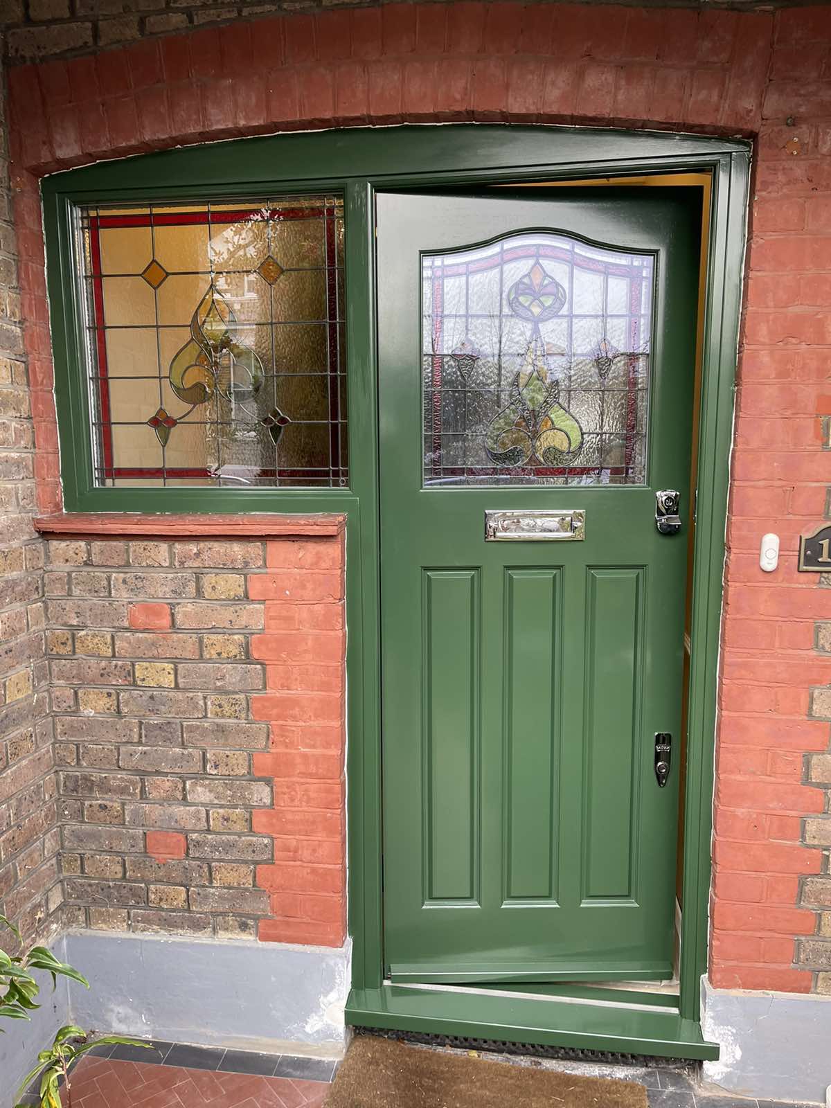 1920s olive front door with stained glass transom windows