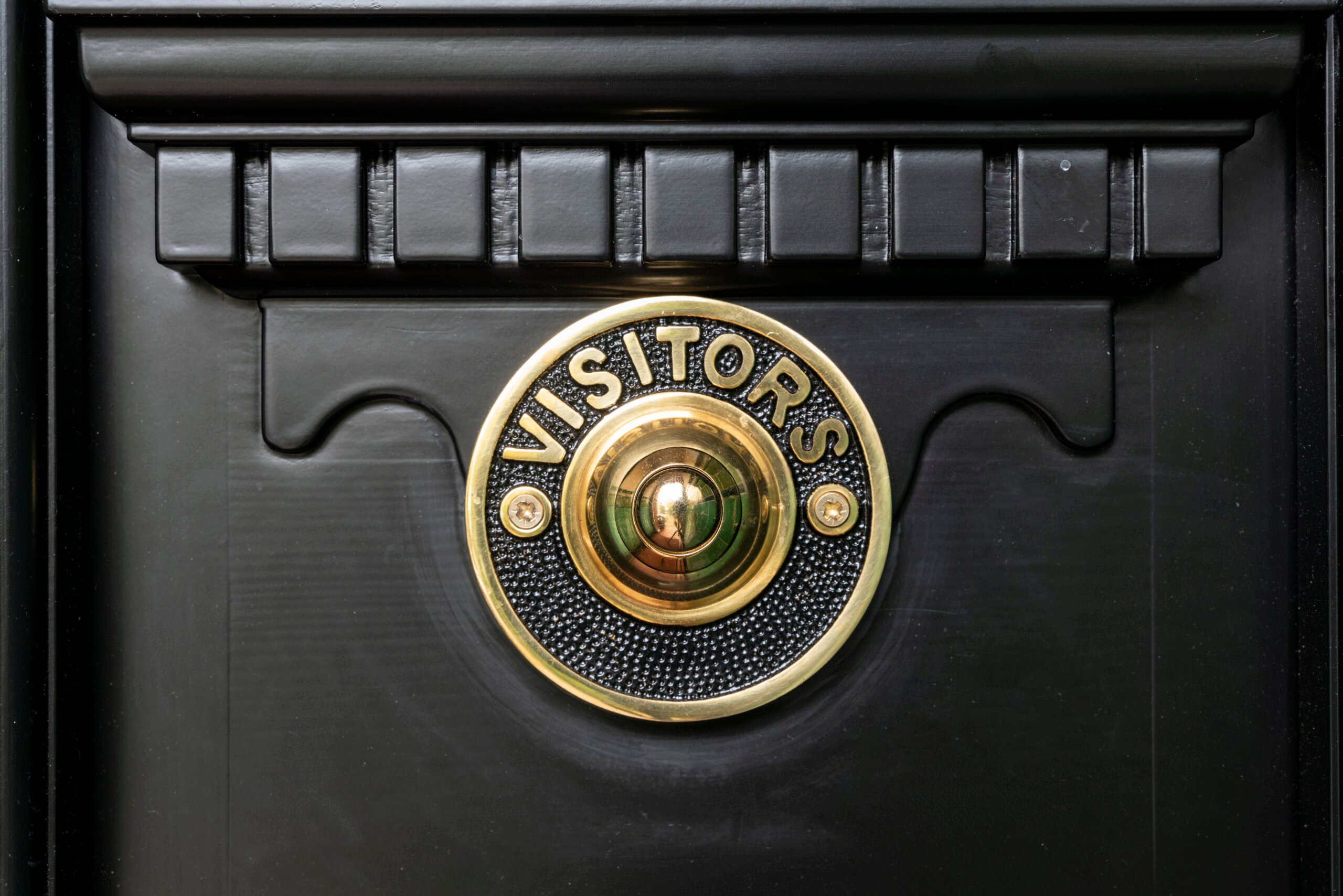 Black door with bronze peephole