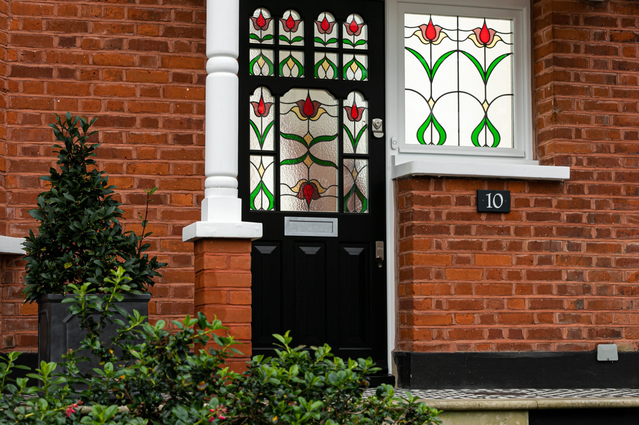 Black front door with floral stained glass