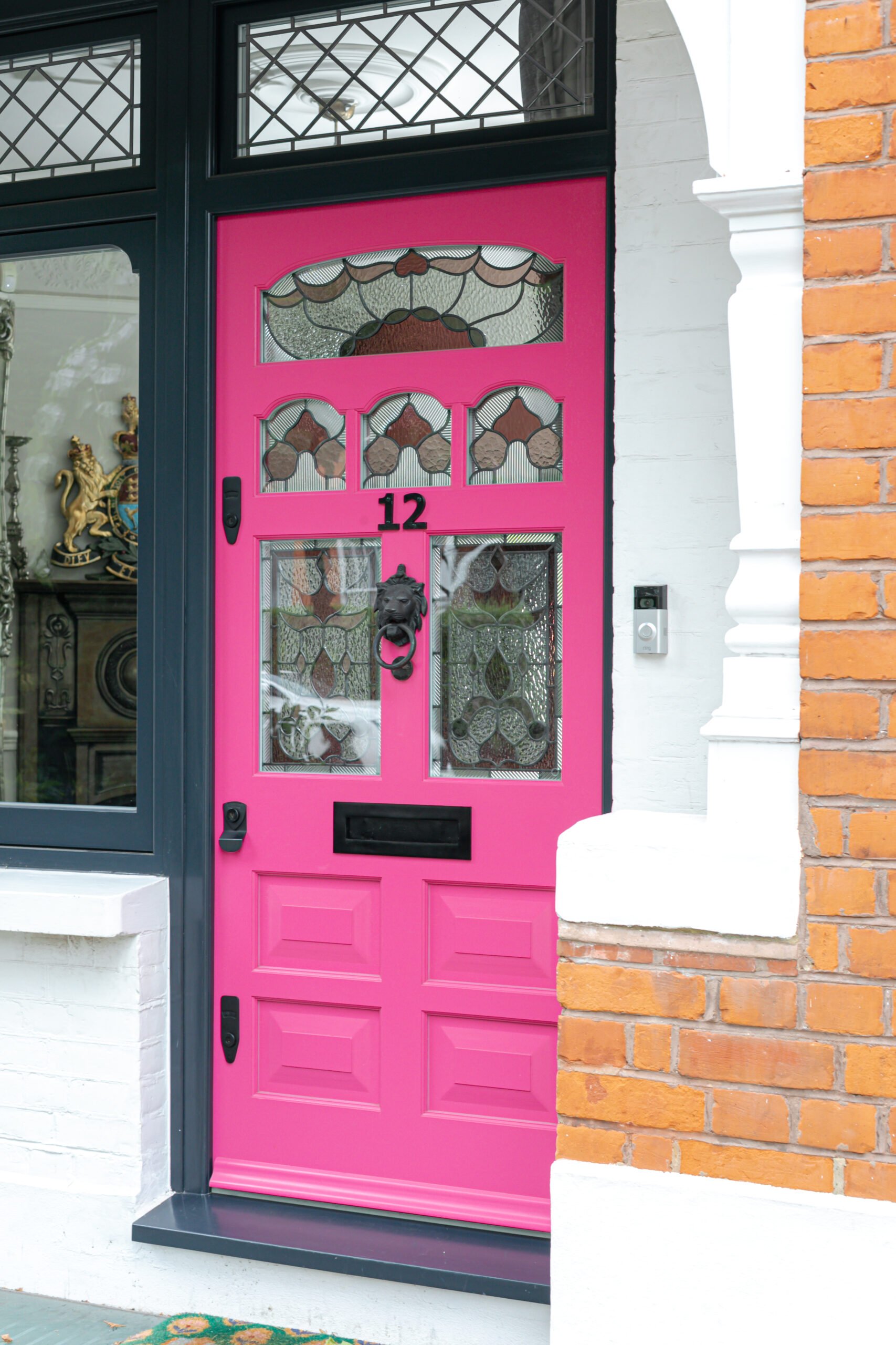 Ornate pink front door with detailed stained glass