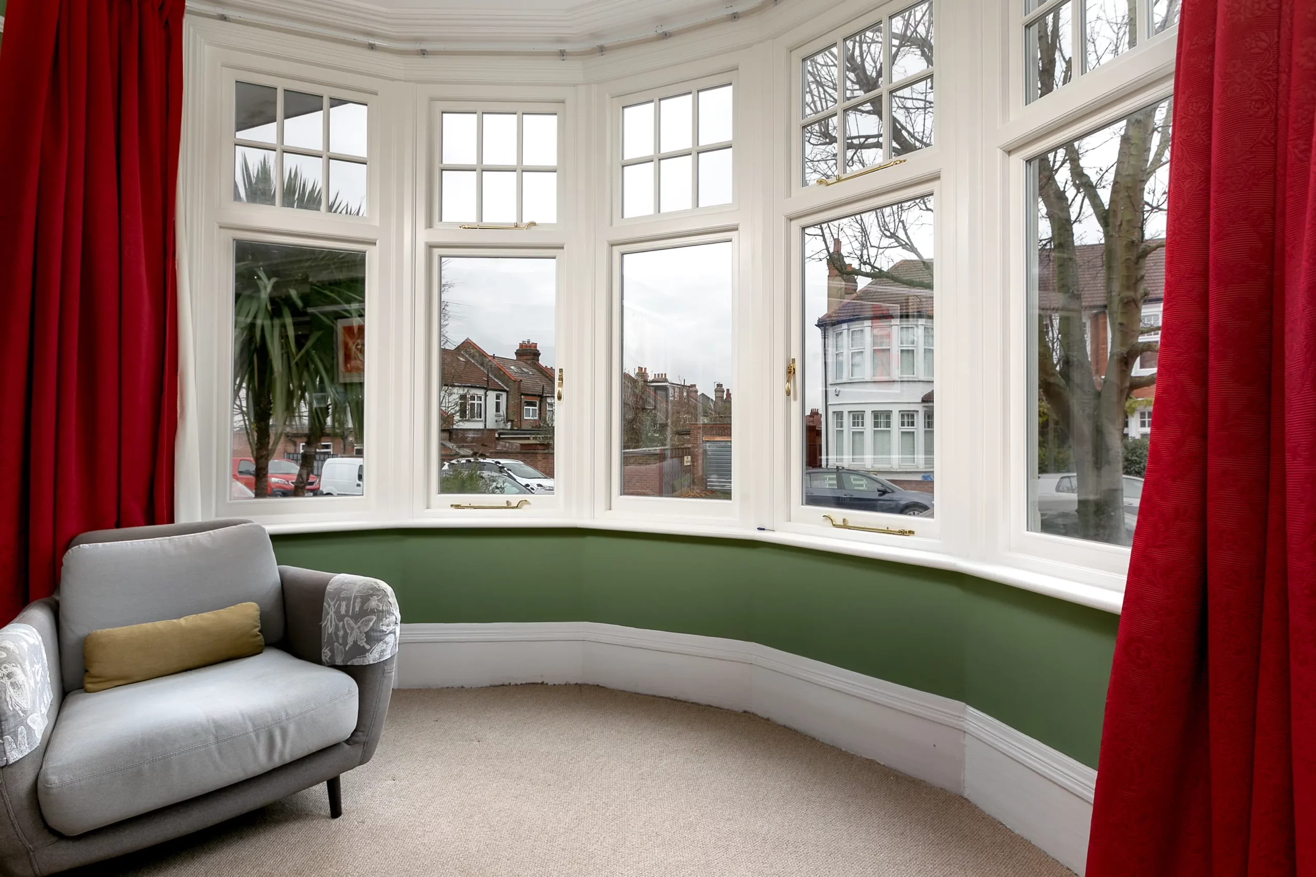 Curved bay room with white 1930s style windows