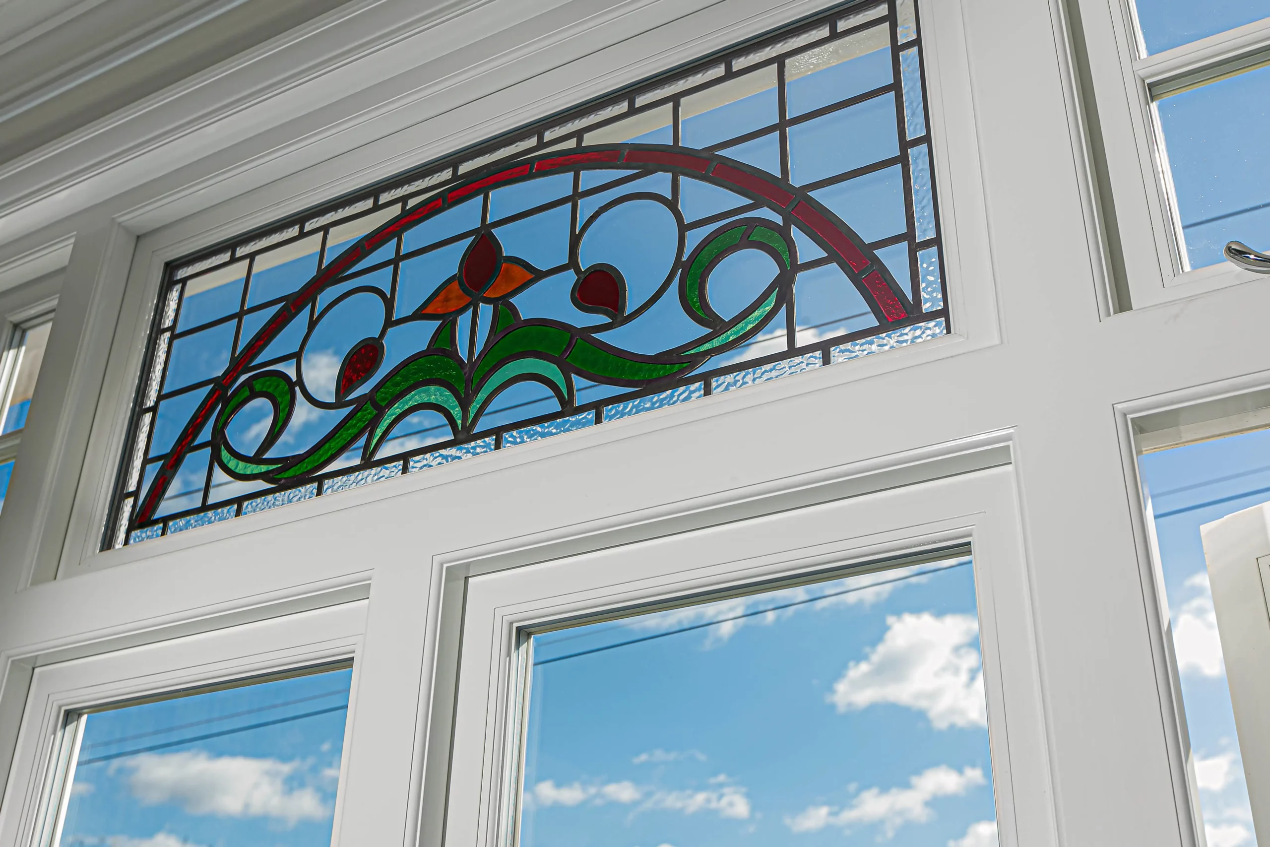 Decorative stained glass above 1930s windows