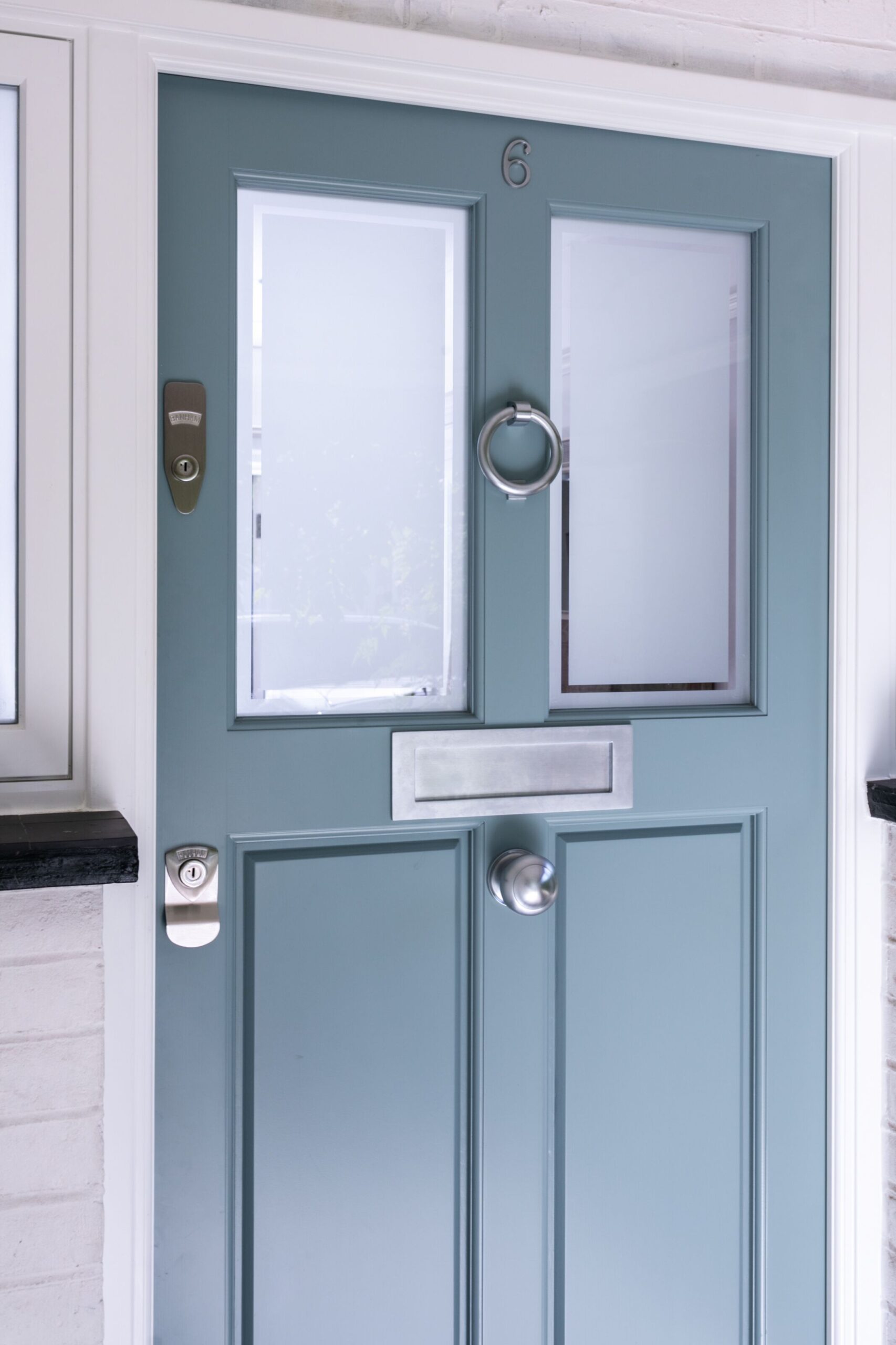 Elegant pale blue door with stainless steel detailing
