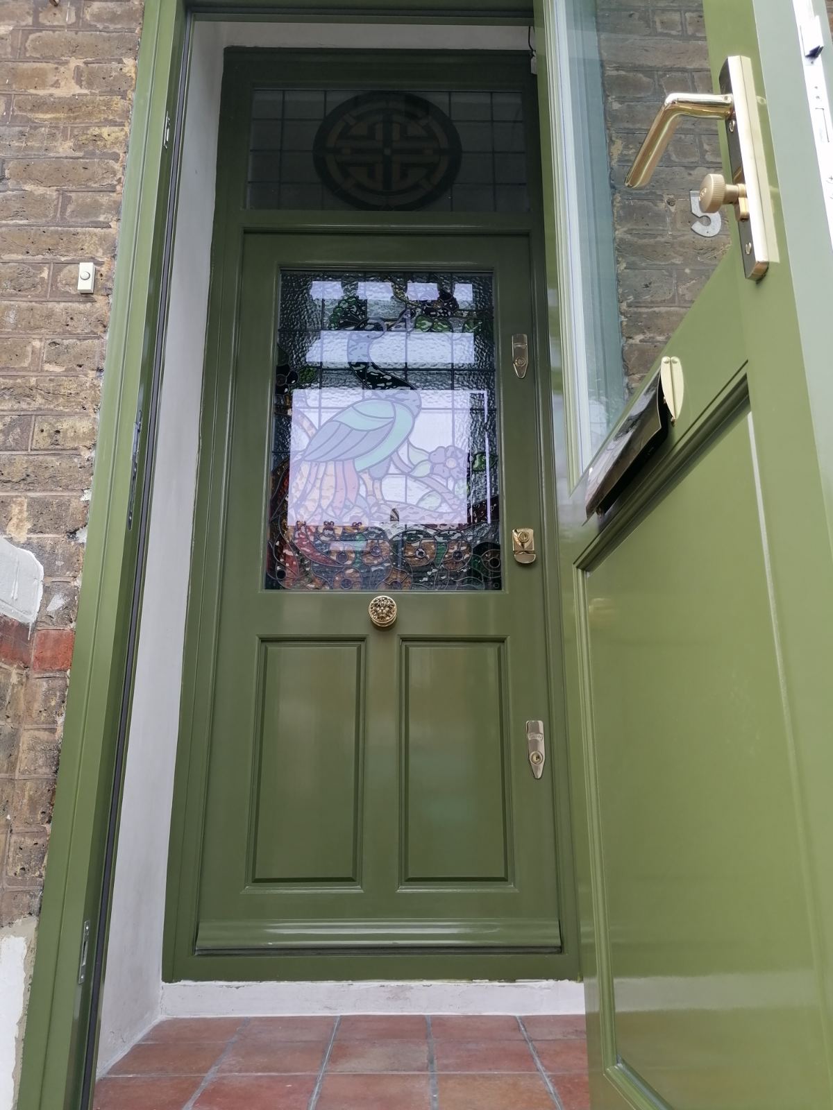 Entrance with two olive front doors