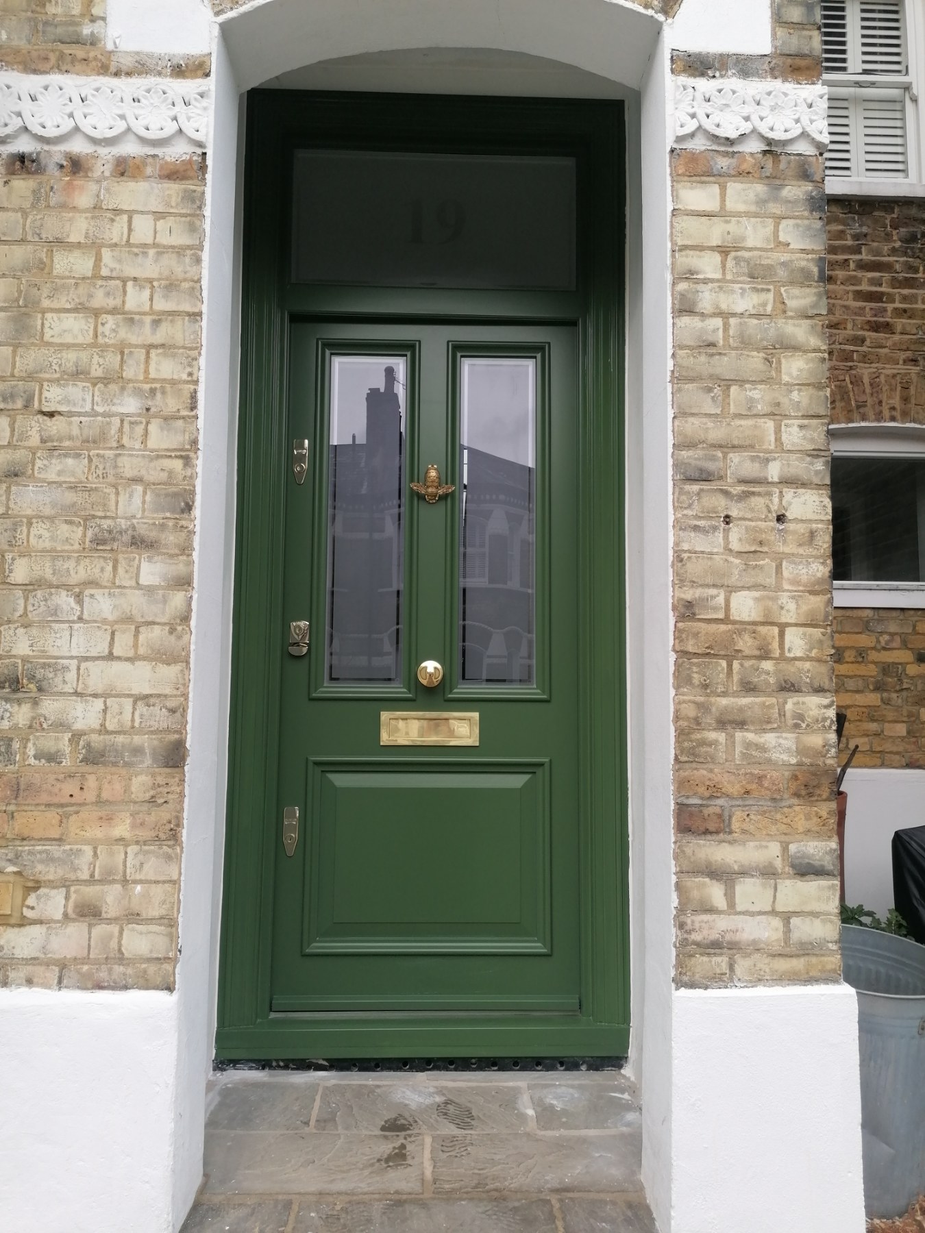 Green front door with glazed panels