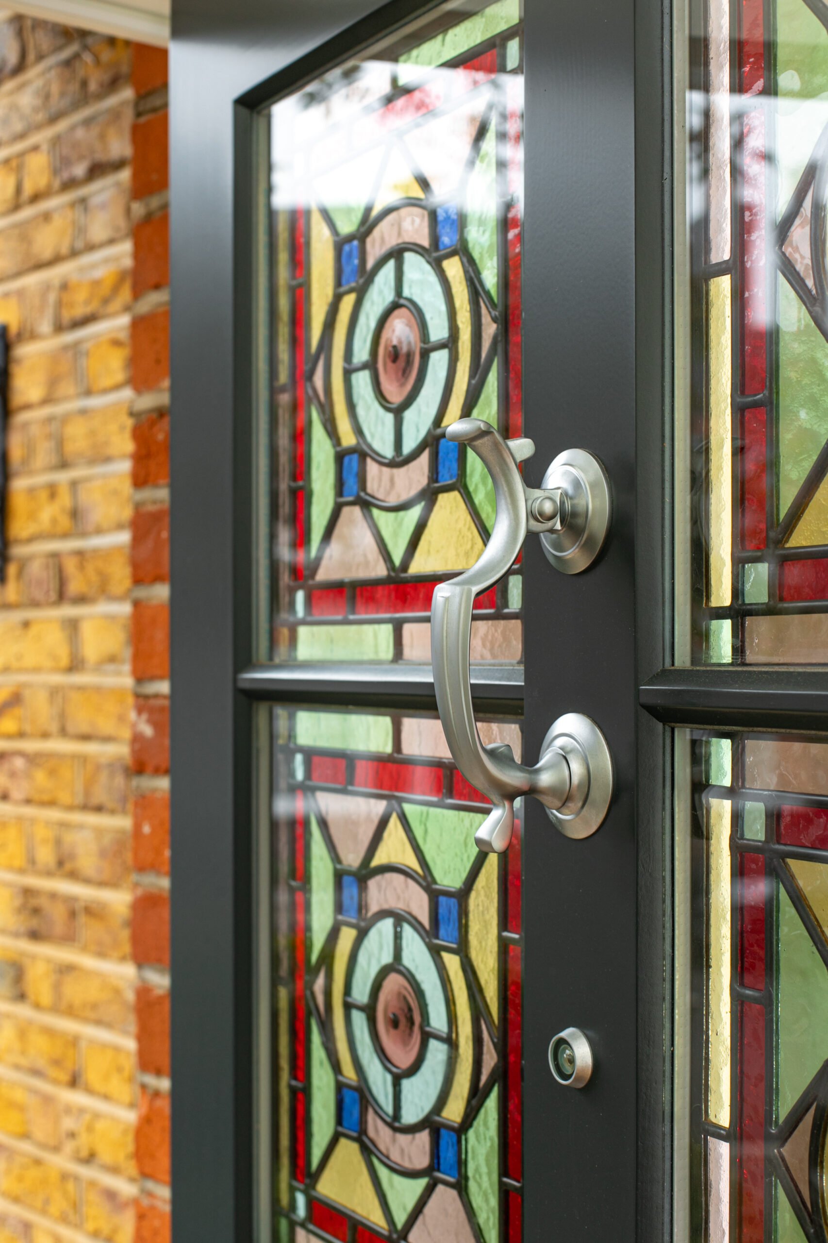 Grey front door with stained glass