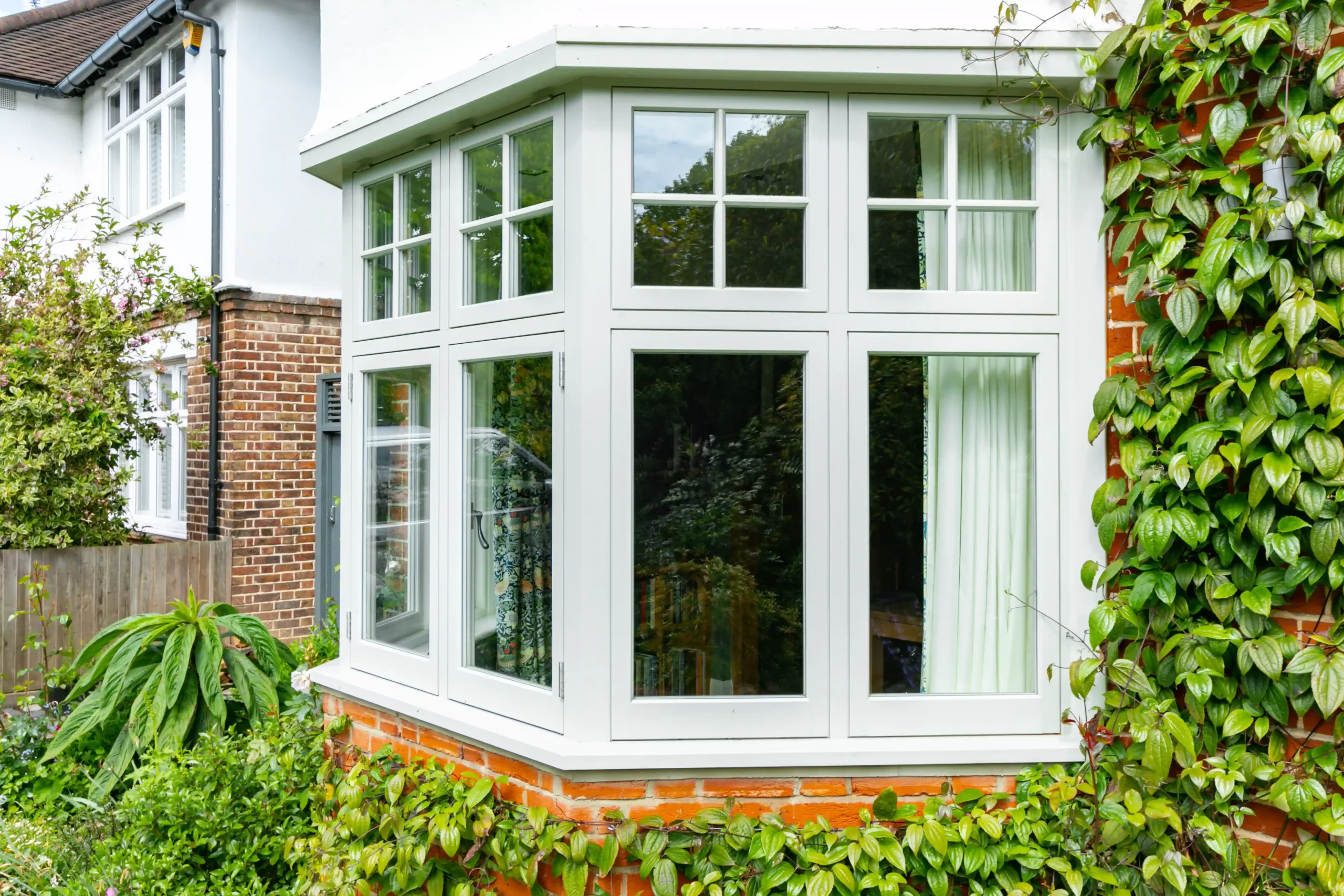 Grey-painted 1930s style windows on a garden extension