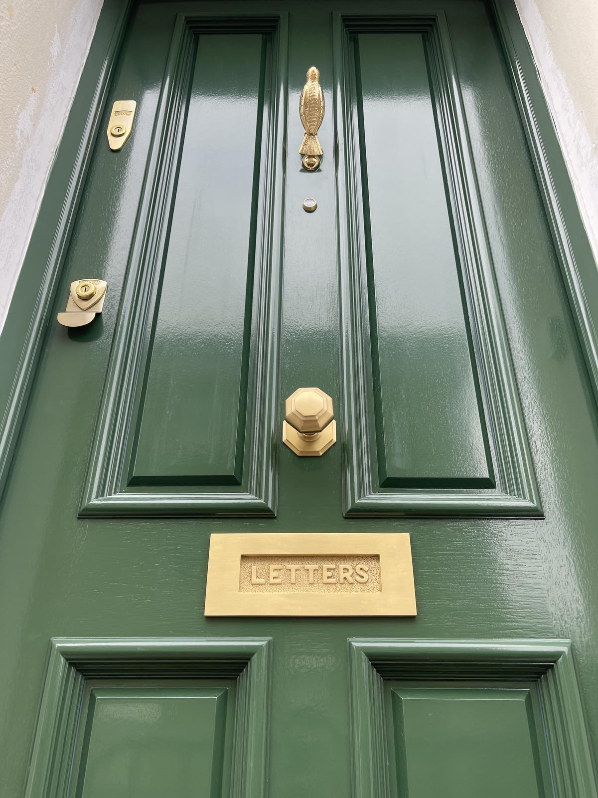 Olive green front door with elegant styling