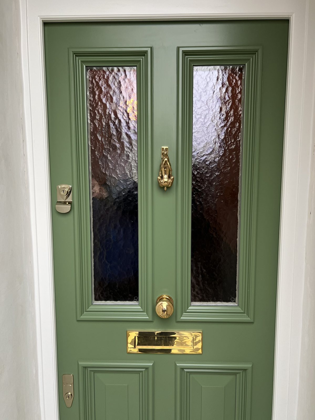 Olive green front door with textured glass