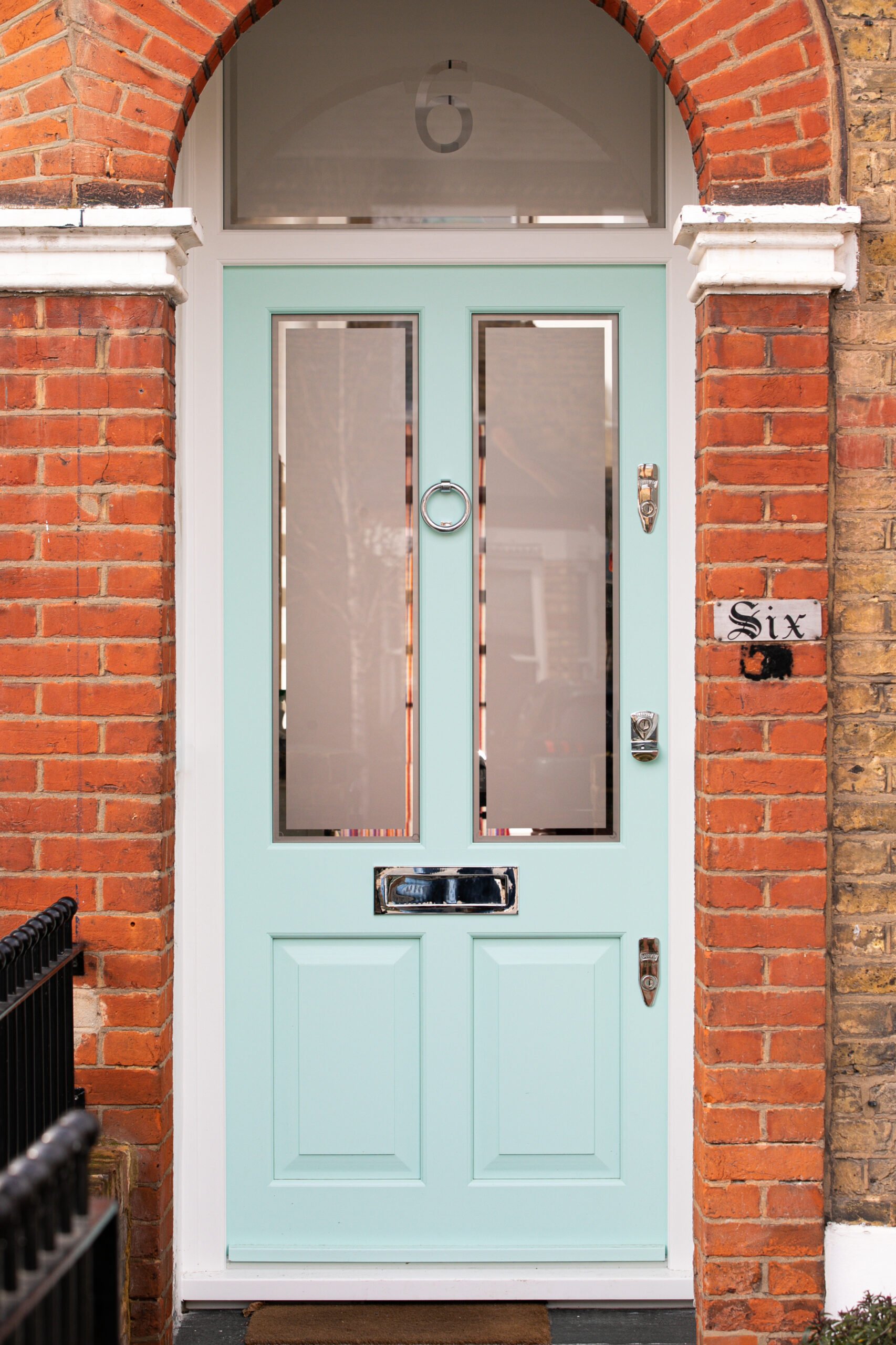 Pale blue front door with clear transom window