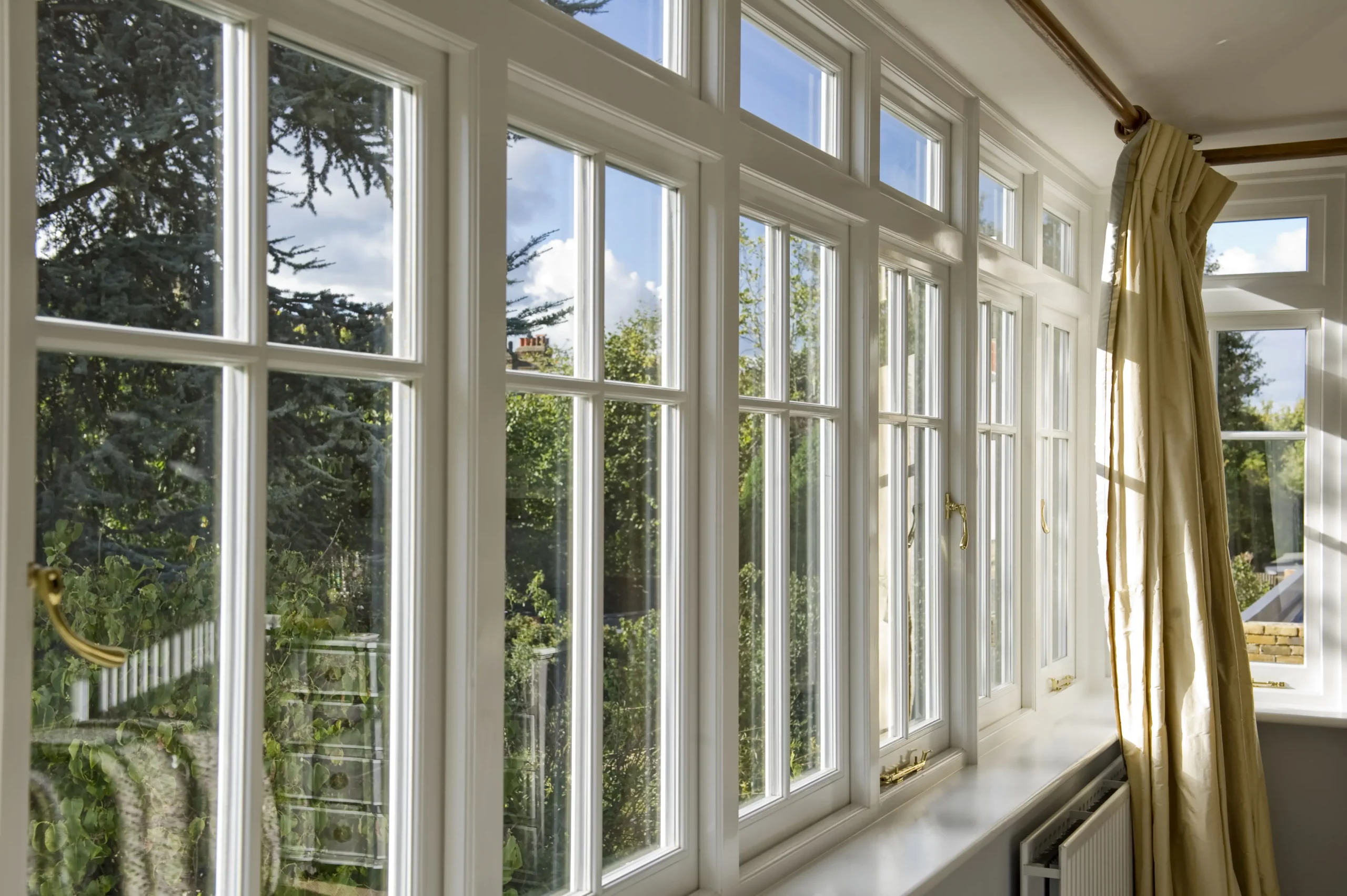Row of bespoke 1930s style windows in a bright interior
