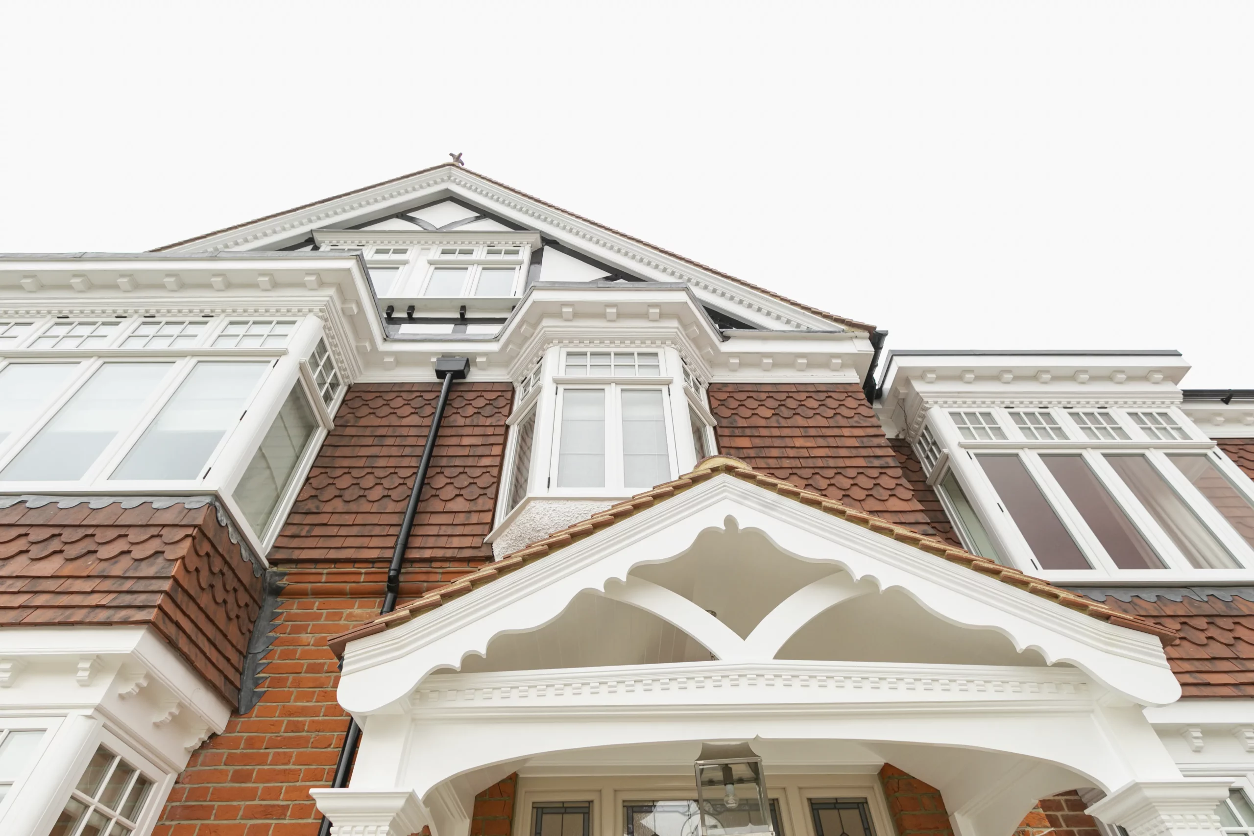 Tall bay with white 1930s windows and shutters