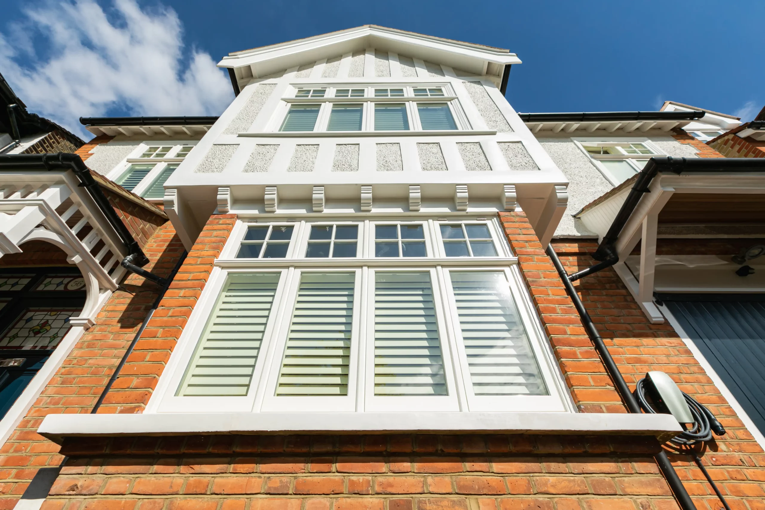 Tall exterior view of 1930s style windows on a period home