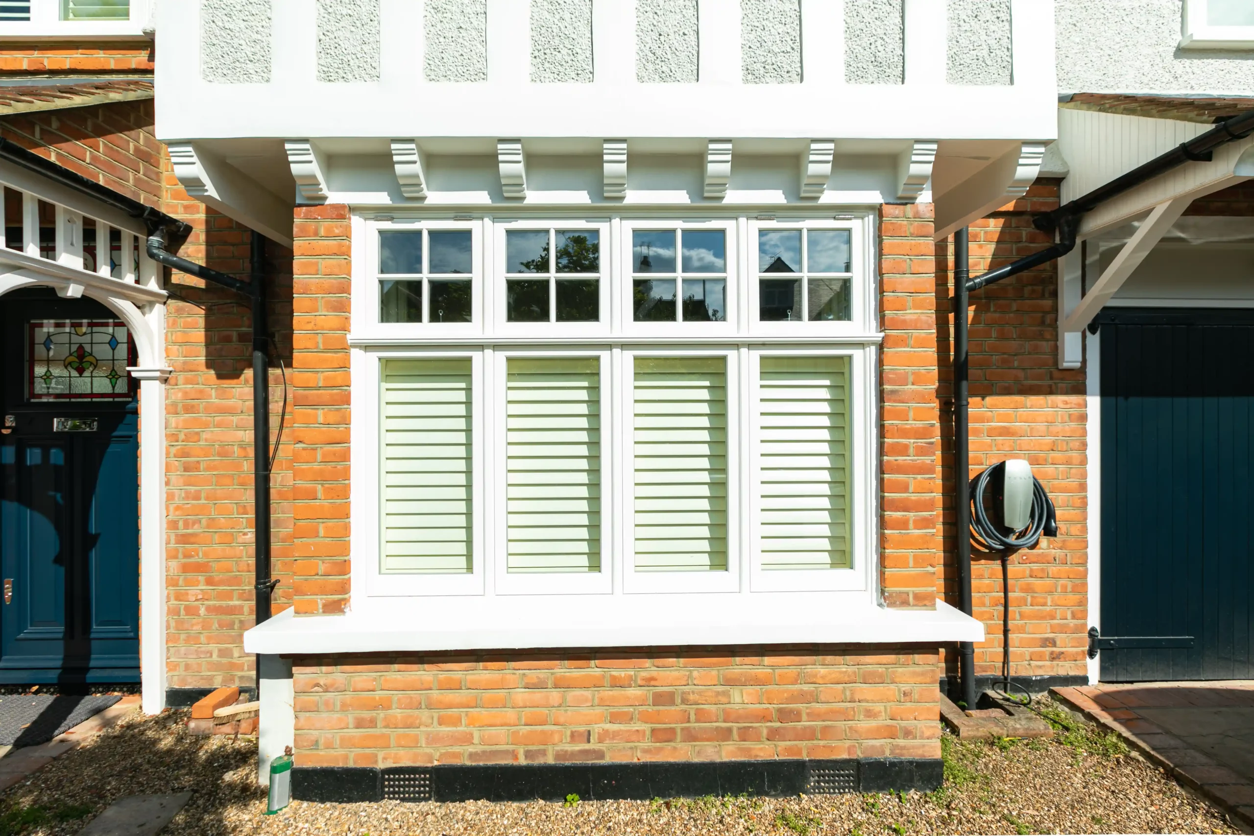 White 1930s style widows against brick