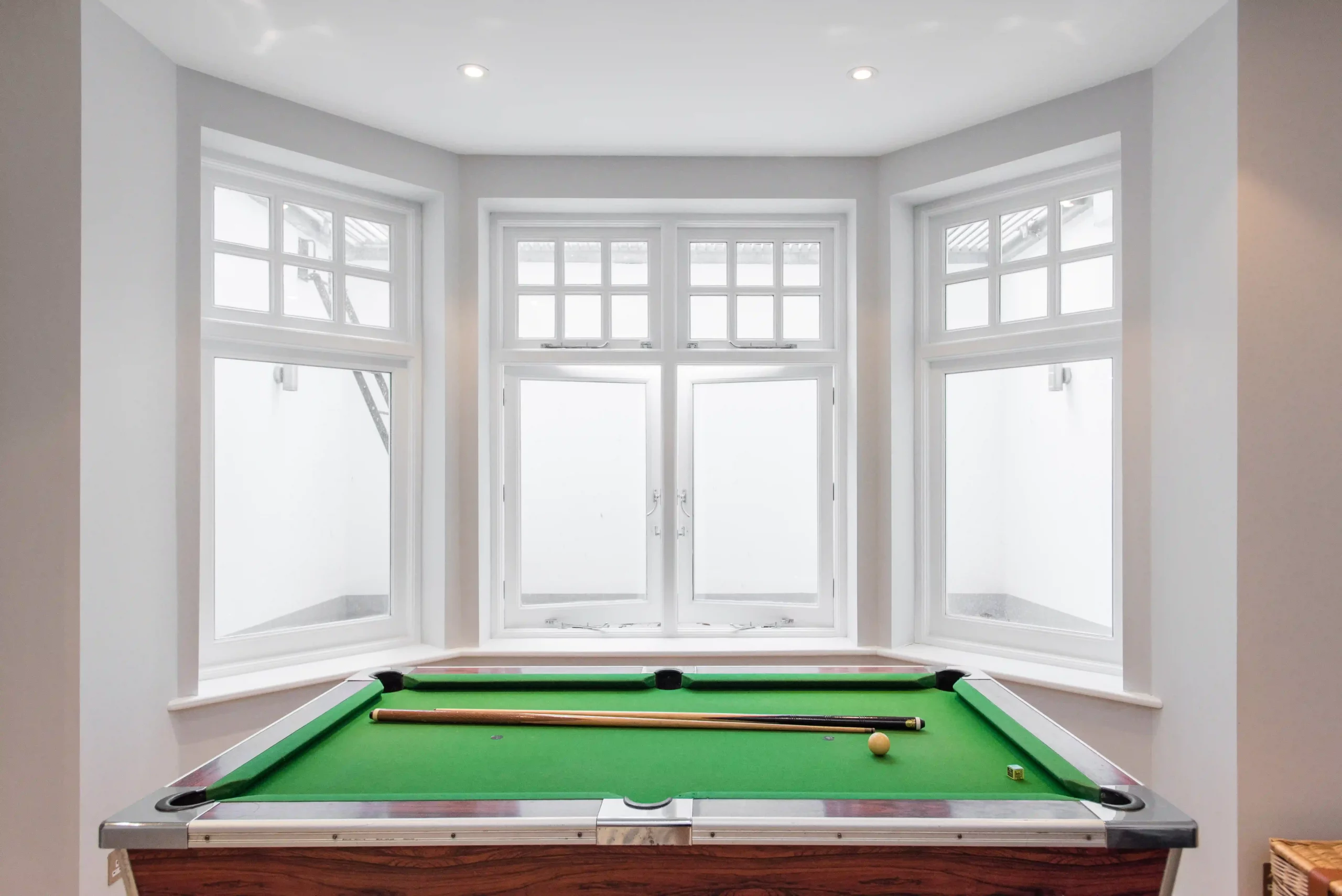 White 1930s windows in a modern bay room