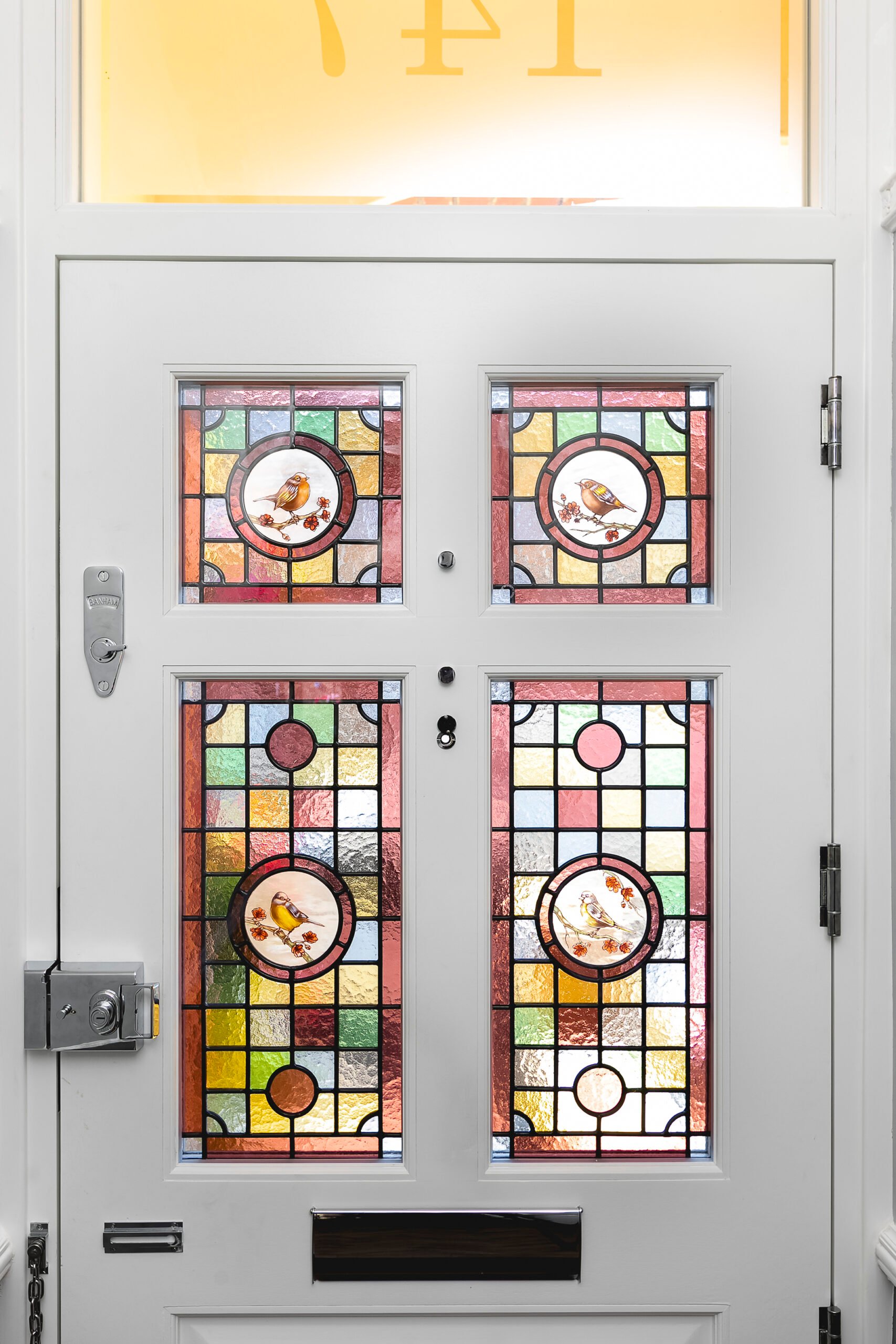 White front door with stained glass
