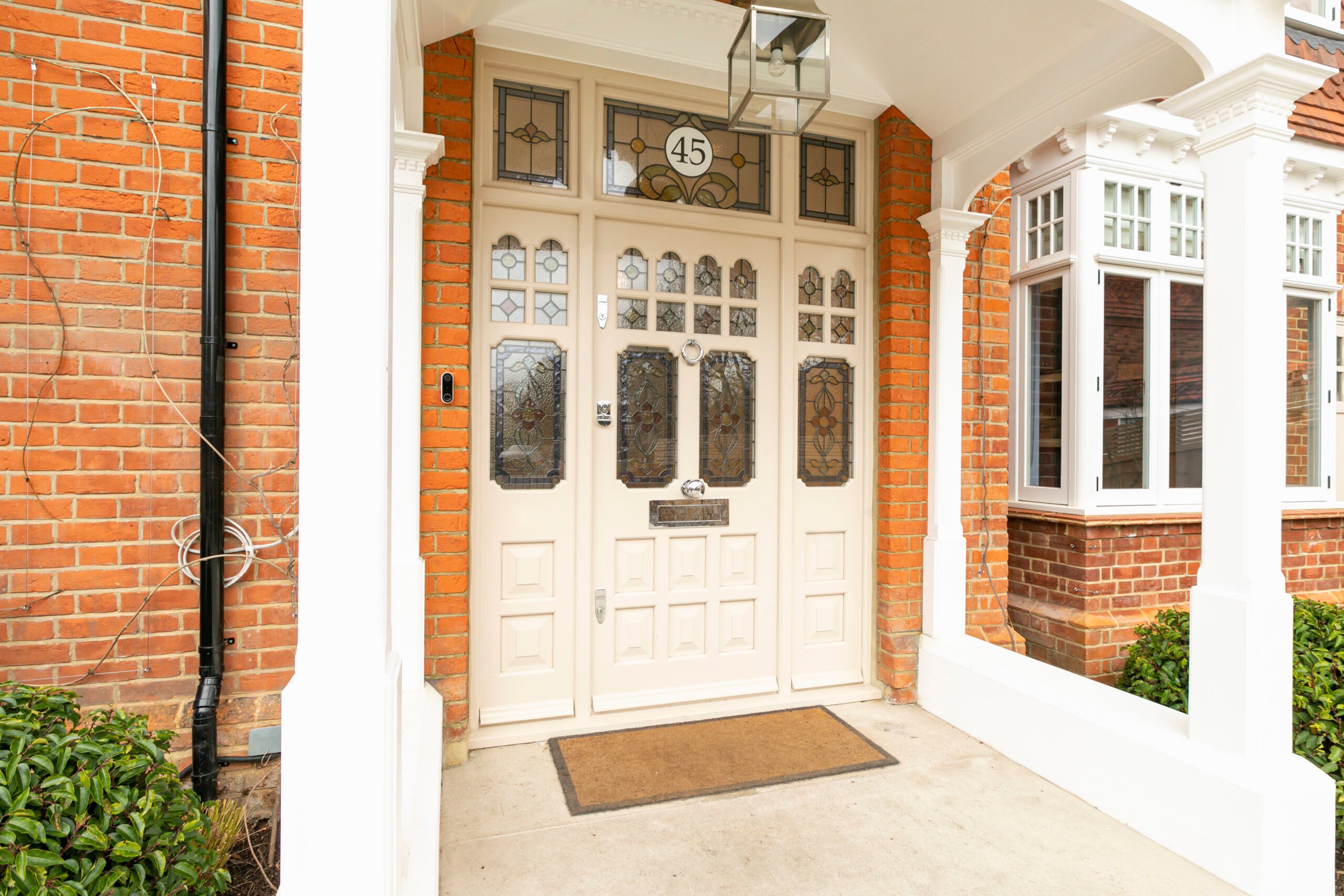 White front door with transom windows and sidelights