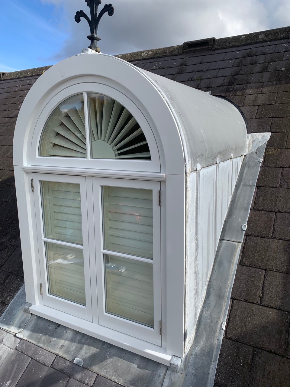 arched dormer window with shutters