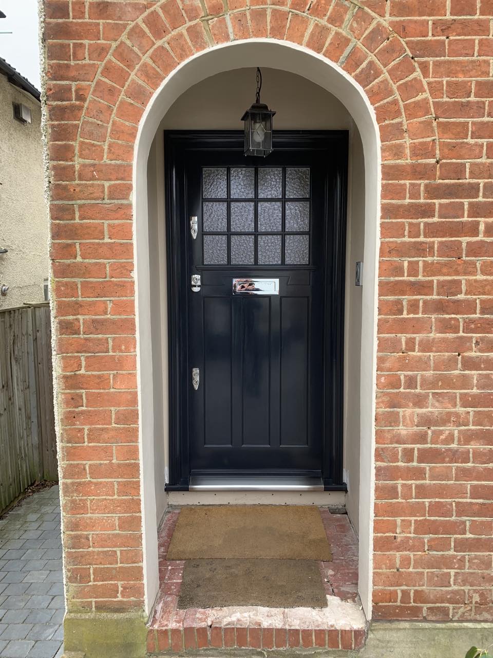 black front door with brick entrance