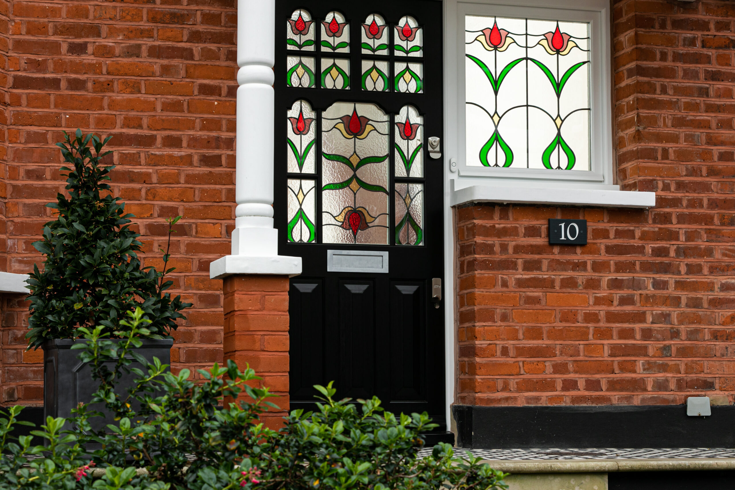 black front door with stained glass inlay