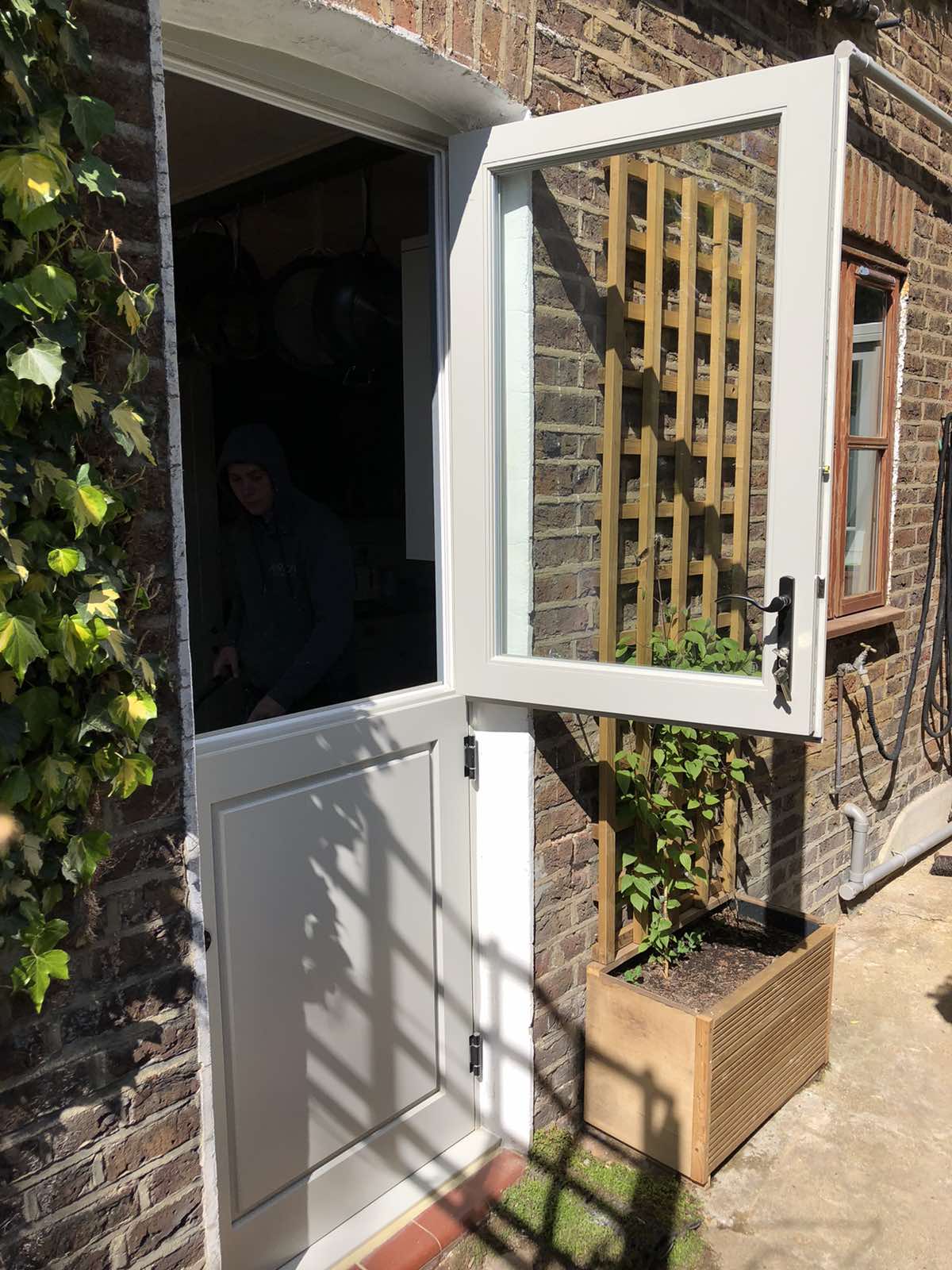 white side entrance door open to garden