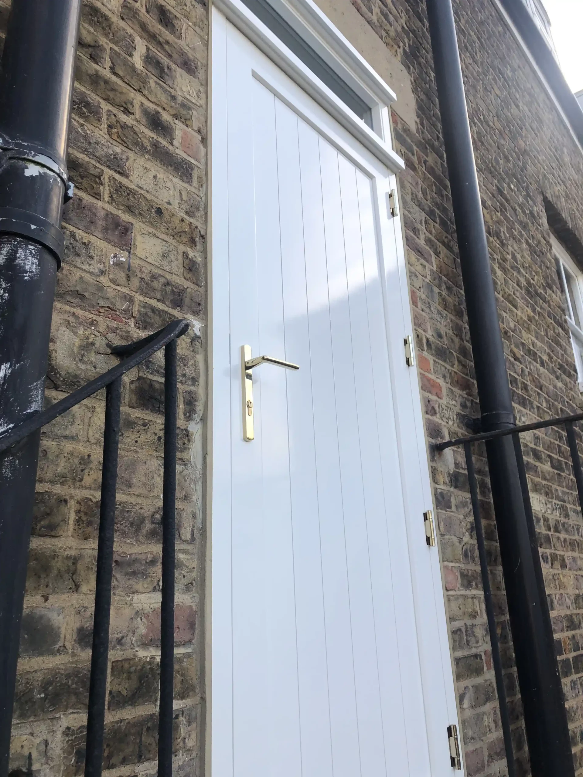 white timber exterior door with top light